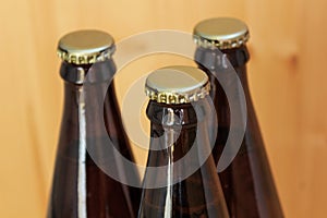 Beer bottles, chilled drinks close-up, on wooden background