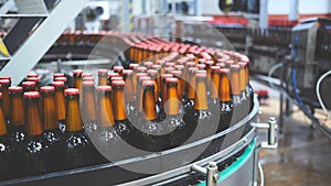 Beer bottles on the conveyor belt. Shallow dof. Selective focus.