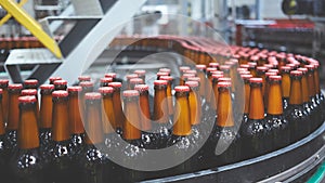 Beer bottles on the conveyor belt. Shallow dof. Selective focus.