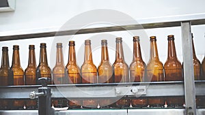 Beer bottles on the conveyor belt. Shallow dof. Selective focus.