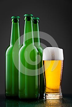 Beer bottles with full glass