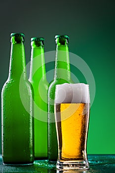 Beer bottles with full glass