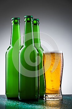 Beer bottles with full glass