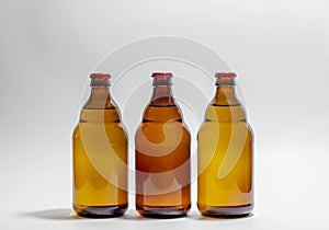 Beer bottles with a red cork on a gray background. Design. Minimalism. Creative idea. Mock-up
