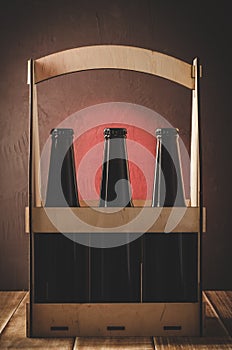 beer bottles in a wooden case on wooden shelf/beer bottles in a wooden case on wooden shelf. Selective focus