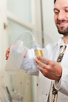 Beer Brewer in food laboratory examining