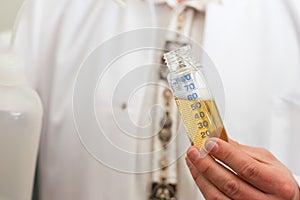 Beer Brewer in food laboratory examining