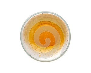 Beer bubbles in glass cup on white background. top view