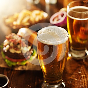 Beer and burgers on wooden table