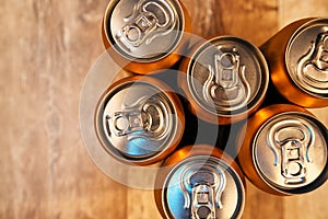 Beer cans on rustic wooden table top view