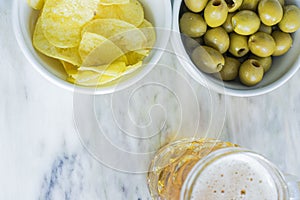 Beer with chips and olives