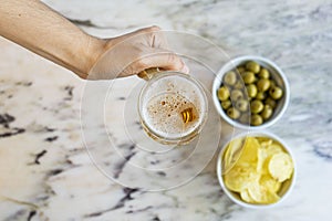 Beer with chips and olives