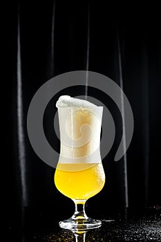 Beer. Cold Craft light Beer in a glass with water drops. Pint of Beer into a tall glass with a thick foam