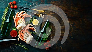 Beer and crab claws on a black background. Rustic style.