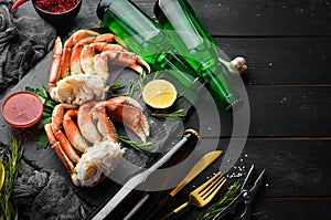 Beer and crab claws on a black background. Rustic style.