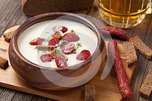 Beer cream white soup with sausages and croutons