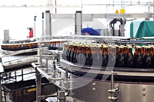 Beer filling in a brewery - conveyor belt with glass bottles