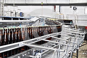 Beer filling in a brewery - conveyor belt with glass bottles