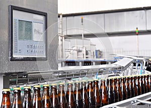 Beer filling in a brewery - conveyor belt with glass bottles