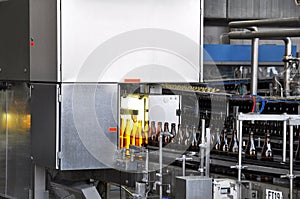 Beer filling in a brewery - conveyor belt with glass bottles