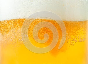 Beer and foam close-up background. Beer texture