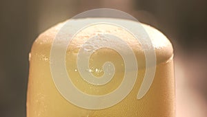 Beer foam cutting with knife, close up.