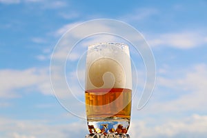 Beer with foam in a glass with a beautiful background