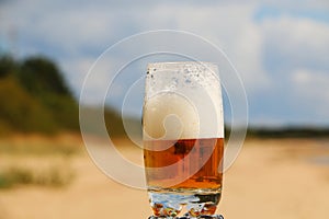 Beer with foam in a glass with a beautiful background