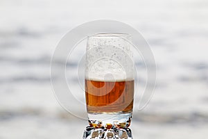 Beer with foam in a glass with a beautiful background