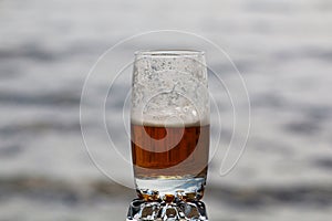 Beer with foam in a glass with a beautiful background