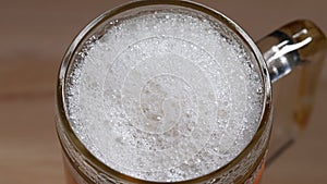Beer foam in a glass. Slow motion