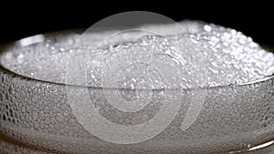 Beer foam in a glass. Slow motion