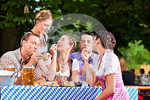 In Beer garden - friends on a table with beer