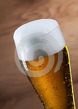 Beer. Gass of beer on wooden background