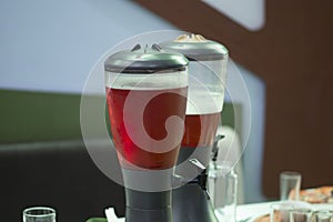 Beer in glass barrels on the table in the Beer Bar