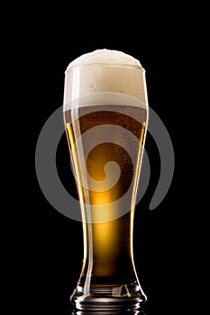 Beer into glass on a black