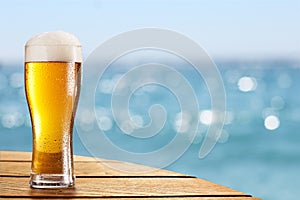 Beer glass on a blurred background of the sea.