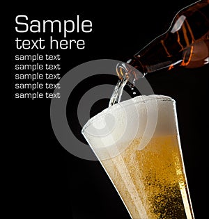 Beer glass and bottle on a black