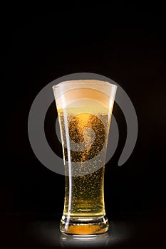 Beer glass with bubbles whirl