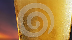 Beer glass close-up. In a glass of beer foam and bubbles in slow motion. In a glass of beer foam and bubbles in slow