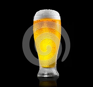 Beer. Glass of cold beer with water drops. Craft beer isolated on black