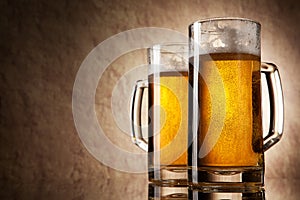 Beer into glass on a old stone background