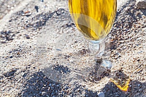 Beer glass on the sand