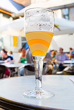 Beer in glass on table in street cafe, Europe