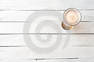 Beer glass on white vintage background with copyspace.