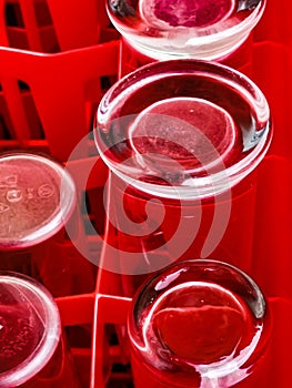 Beer glasses from Cologne in a red transport Box to use for KÃ¶lsch