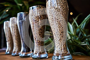 Beer glasses filled with different malts and hops, close-up