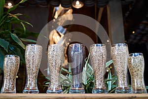 Beer glasses filled with different malts and hops, close-up photo