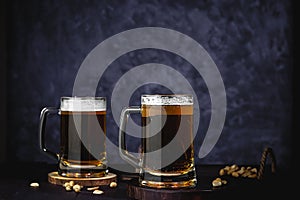 Beer glasses with lager, dark lager, brown ale, malt and stout beer on table, dark wooden background