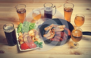 Beer, grilled sausages and roasted potato